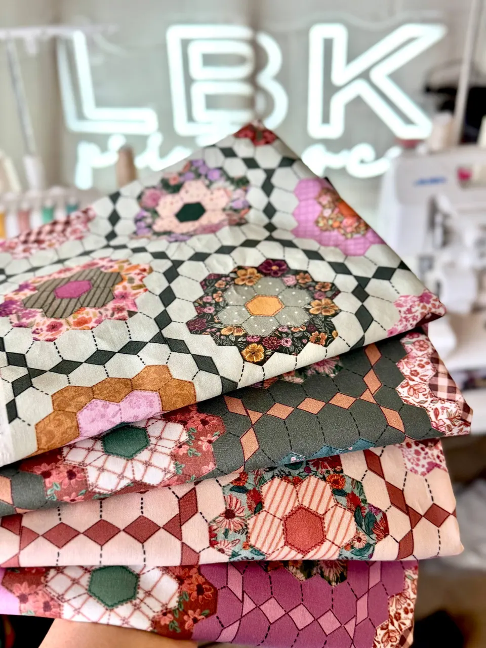 A stack of colorful custom-printed quilt fabrics in the LBK Printing studio