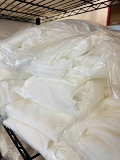 Bags of white fabric base end-of-roll pieces